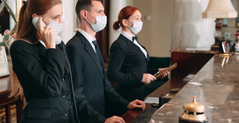 hotel receptionists wearing masks